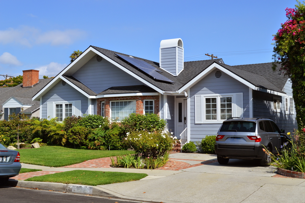 Beautiful home with garage showcasing residential roof replacement